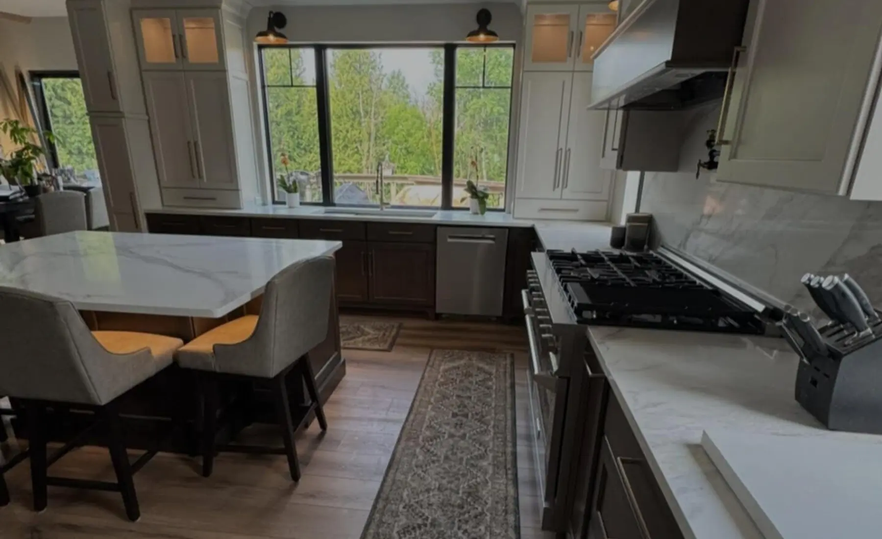 White marble-look kitchen island and window installed by Counterstone